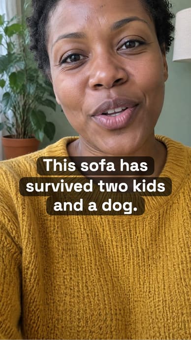 Example ad, the furniture store’s Reel at 0:00: a close shot of a woman in a mustard jumper talking to camera, the caption “This sofa has survived two kids and a dog.” burned in just below her chin.