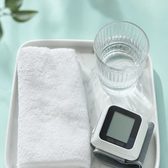 Example frame: a tray with a towel, a glass of water and a blood-pressure monitor